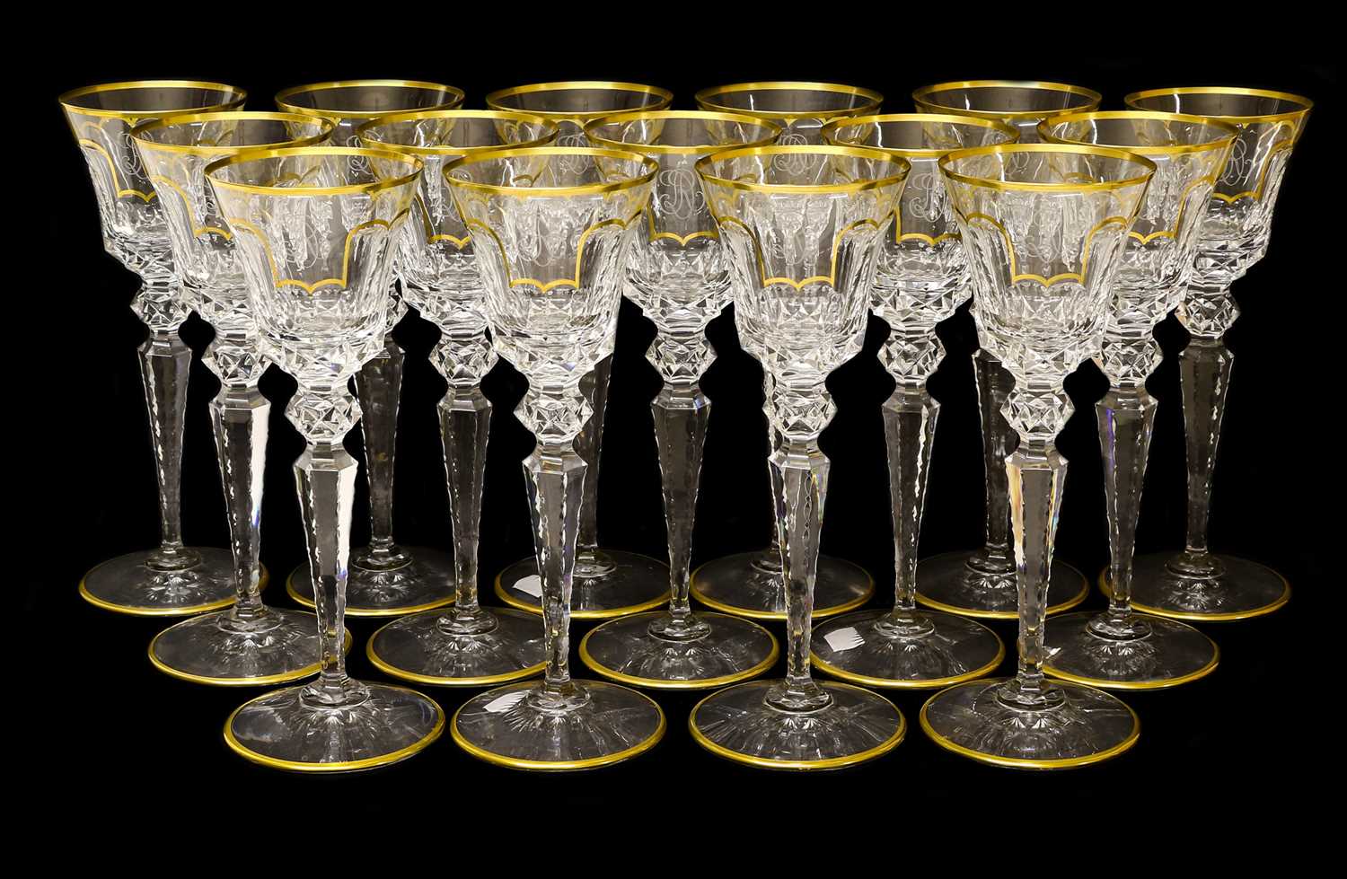 A Set of Fifteen St Louis Red Wine Glasses, 20th century, the panelled funnel bowls engraved with