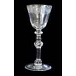 A Newcastle Wine Glass, circa 1740, the rounded funnel bowl engraved with a band of flowers, lattice