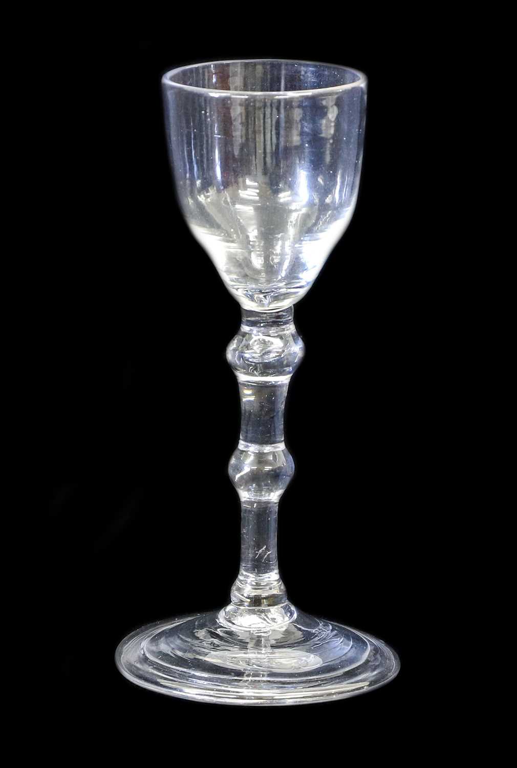 A Balustroid Wine Glass, circa 1740, the ogee bowl on a double ball-knopped plain stem and folded