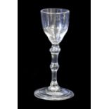 A Balustroid Wine Glass, circa 1740, the ogee bowl on a double ball-knopped plain stem and folded