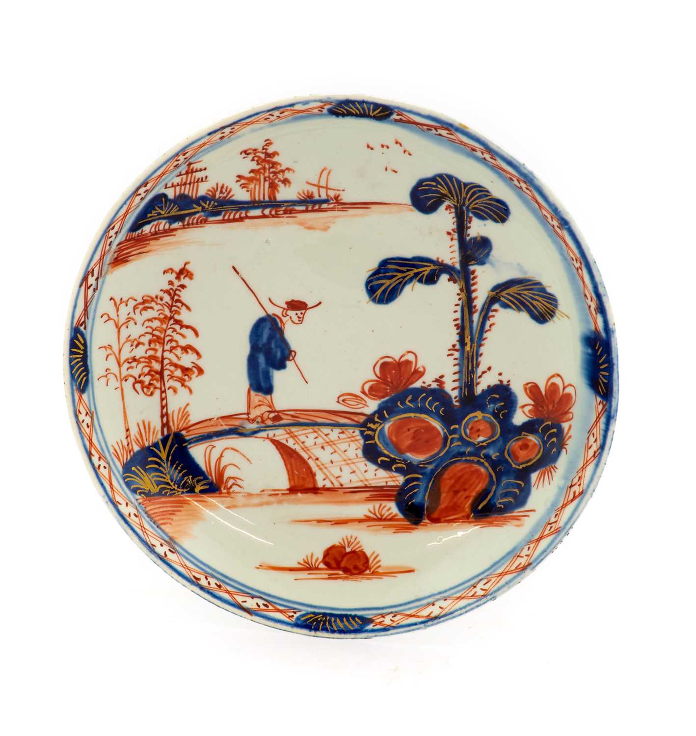 A Vauxhall Porcelain Saucer, circa 1755, painted in Chinese Imari style with a figure crossing a