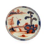 A Vauxhall Porcelain Saucer, circa 1755, painted in Chinese Imari style with a figure crossing a