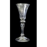 A Cordial Glass, circa 1750, the drawn trumpet bowl on a plain stem and folded foot17cm high