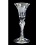 A Wine Glass, circa 1750, the bell shaped bowl engraved with fruiting vine on an inverted baluster