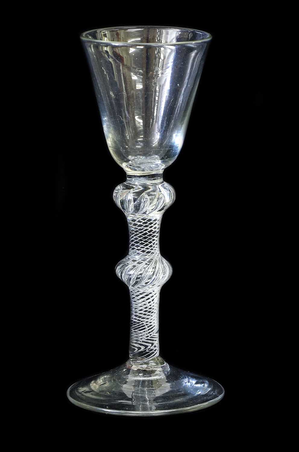 A Wine Glass, circa 1755, the rounded funnel bowl on a double-knopped air twist stem and circular