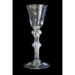 A Wine Glass, circa 1755, the rounded funnel bowl on a double-knopped air twist stem and circular