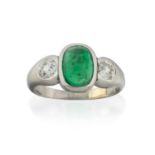 An Emerald and Diamond Three Stone Ring