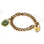 A curb link bracelet with a padlock clasp, stamped '9CT GOLD', suspending an intaglio seal