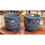 A pair of Wedgwood black basalt jardinieres, sprigged with Lion masks, fruiting vines and