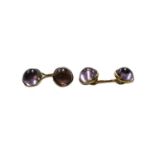 A pair of amethyst cufflinks, stamped '14K'The cufflinks are in fair condition. There is slight