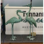 A pair of verdi gris metal garden sculptures formed as Herons, the largest 89cm (2)