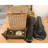 A musical wall clock, a wicker hamper, two cased violins and bows