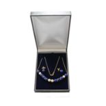 A lapis lazuli, cultured pearl and diamond necklace, clasp stamped '750', length 45cm; another lapis