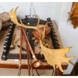 A pair of mounted antlers, a copper coaching horn, various riding crop, a oak wall mounting stick