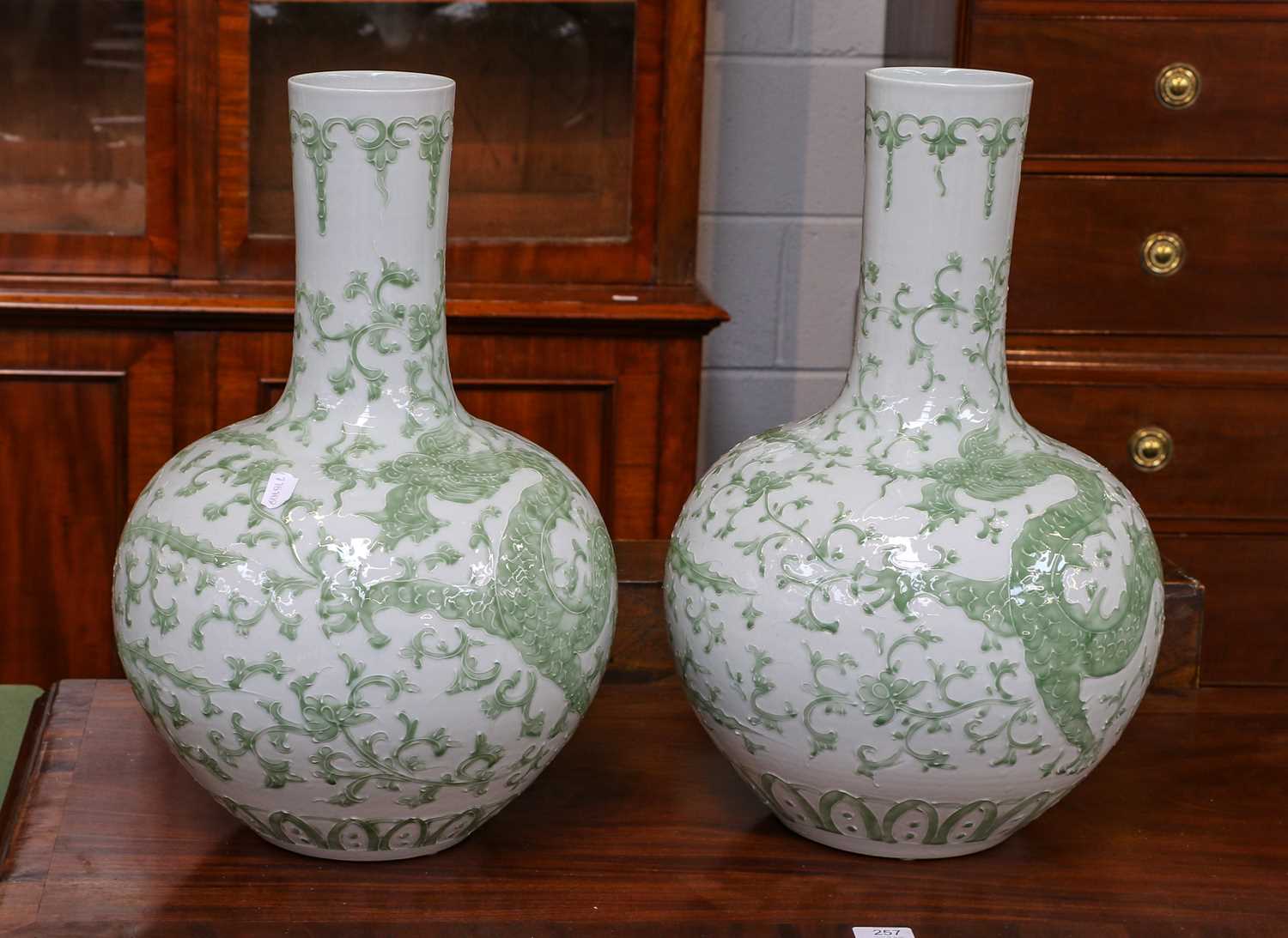 A pair of modern Chinese porcelain bottle vases, decorated with dragons and phoenix, bearing six