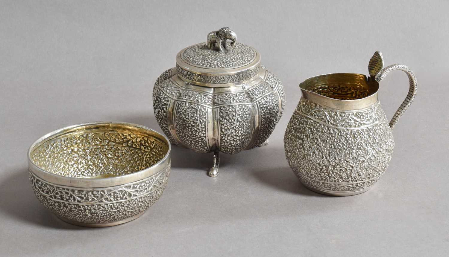 Three Various Indian Silver Items, including: a canister with pull-off cover, with elephant cast