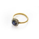 A sapphire and diamond cluster ring, stamped '18CT', finger size LThe ring is in fair condition with