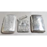 Two Silver Cigar-Cases and A Silver Cigarette-Case, the cigar-cases each curved oblong, one engraved
