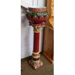 A late 19th/early 20th-century continental majolica jardiniere on stand, claret ground, the stand as