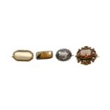 An amethyst brooch; a topaz brooch; and two hardstone brooches, of varying designsGross weight 17.