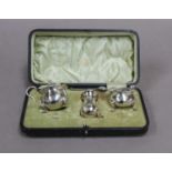 A Cased George V Silver Condiment-Set, by Walker and Hall, Sheffield, 1912 and 1913, in fitted case,