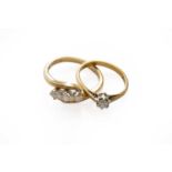 A 9 carat gold diamond three stone twist ring, finger size M; and an 18 carat gold diamond solitaire