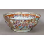 A Chinese porcelain punch bowl, Qianlong, painted in famille rose enamels with figures in gardens