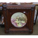A 19th century pottery wall charger in gothic revival oak frame, painted with still life wild