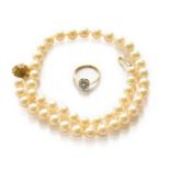 A diamond cluster ring, stamped '18CT', finger size L; and a cultured pearl necklace knotted to an