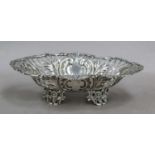 A Victorian Silver Sweetmeat-Dish, by William Hutton and Sons Ltd., London, 1897, oval and on four