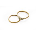 An 18 carat gold diamond solitaire ring, finger size N; and a 22 carat gold band ring, out of