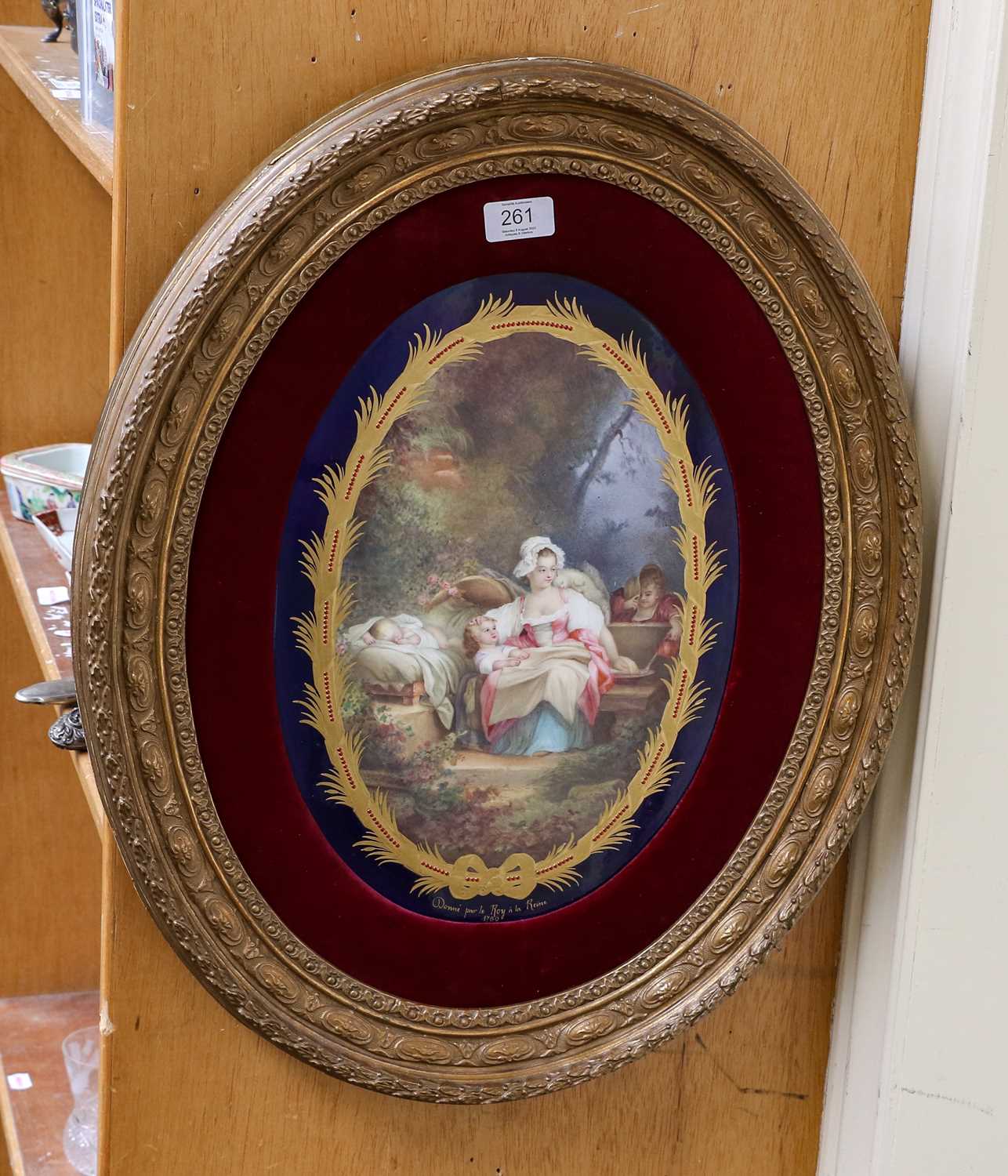 A Sèvres style porcelain plaque, late 19th century, of oval form, painted with a mother and children