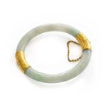 A jade hinged bangle, two sections of jade joined by yellow textured caps, inner measurements 5.