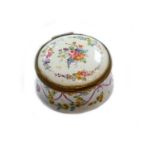 An 18th century enamel box with hinged cover, painted with a bouquet under a border of trailing