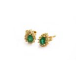 A pair of 14 carat gold emerald and diamond cluster earrings, the pear cut emerald within a border