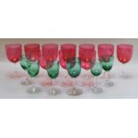 Ten cranberry and six green wine glasses