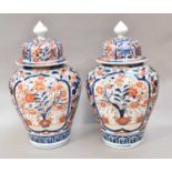 A pair of Japanese Meiji period Imari baluster jars and covers (2)One with a large chip to the rim