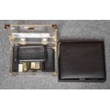 An Alfred Dunhill travel humidor, a Dunhill lighter, a Lino humidor, two leather cigar pouches, a