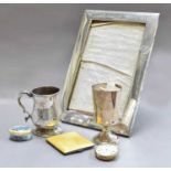 A silver photograph frame, silver and yellow enamel cigarette case, silver christening mug, silver