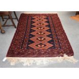 Afghan Rug, the midnight blue field with a column of hexagonal medallions enclosed by geometric