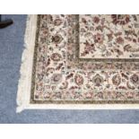 Machine made carpet, the ivory of scrolling vines enclosed by similar palmette borders, 380cm by