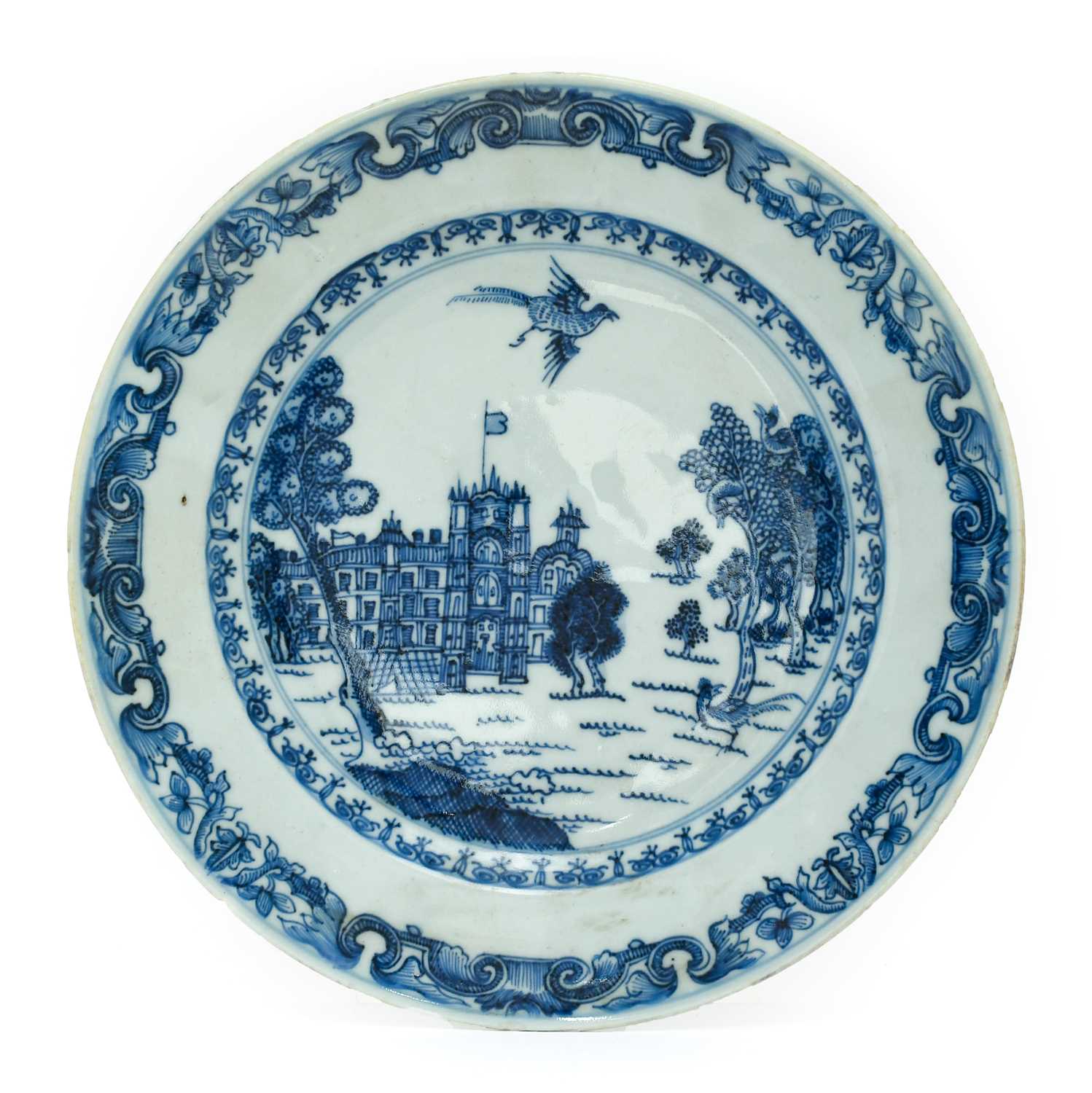 A Chinese Porcelain European Subject Plate, Qianlong, painted in underglaze blue with a palace in