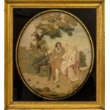 A Silkwork Picture, early 19th century, worked in coloured threads with the Flight into Egypt, oval,