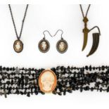 A Six Strand Bead Necklace, by Amedeo, the six strands gathered by a cameo depicting a skull, length