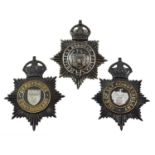 Two Blackened Die Stamped Brass Helmet Plates, each with King's crown over circlet and white metal