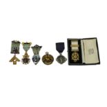 A Collection of Six Masonic Jewels, comprising a 9 carat gold and enamel Past Master breast jewel,