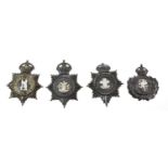 Four Blackened Die Stamped Brass Helmet Plates, each with King's crown over star, circlet and