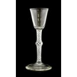 A Mixed Twist Wine Glass, circa 1750, the rounded funnel bowl on a knopped opaque and air twist stem