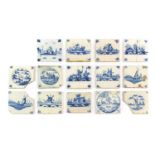 Fourteen Various Delft Tiles, painted in blue with figures and buildings in landscape