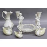 A Small Group of Belkeek China, comprising a ewer, a pair of figural candlesticks, a twin handled